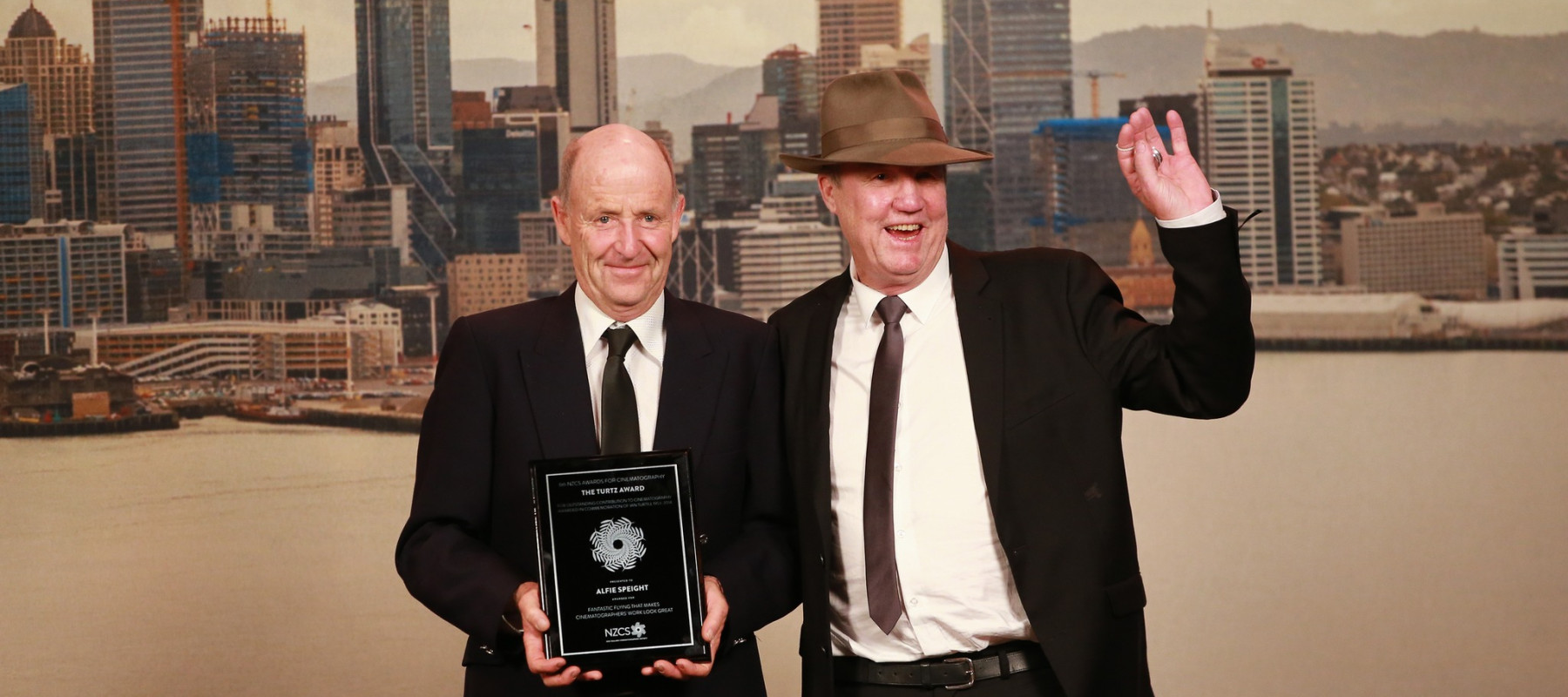 Alfie with award and man in hat